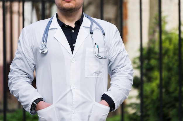 Close-up of a male doctor with stethoscope around his neck at outdoors