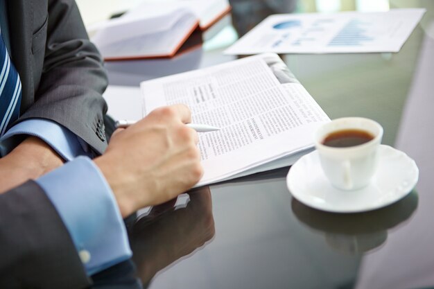 Close-up of male executive reading news