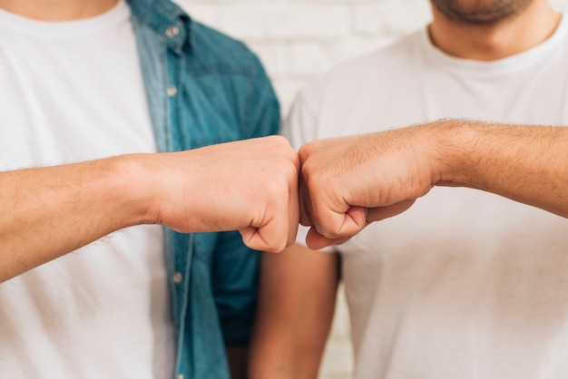 Close-up of male friend touching fist