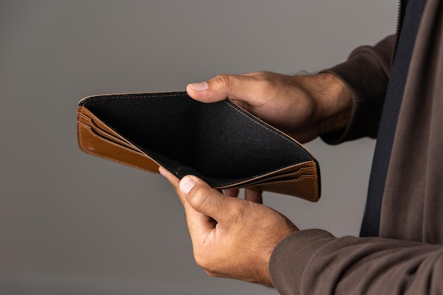 Close up male hand open the empty wallet.there is no money in wallet. financial business concept.