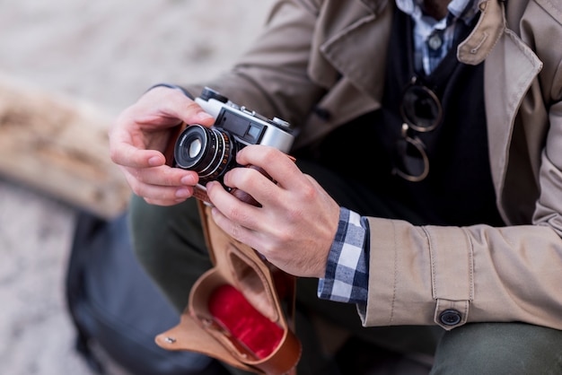 Close-up of a male hiker adjusting the camera