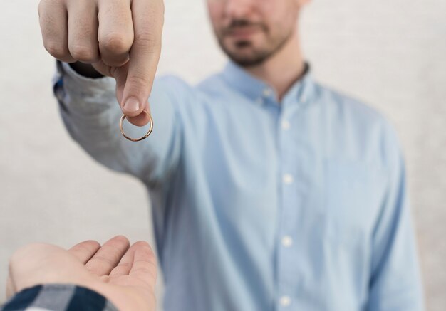 Close-up male holding wedding ring