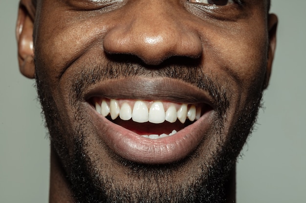 Close-up male mouth with big smile and healthy teeth. Cosmetology, dentistry and beauty care, emotions