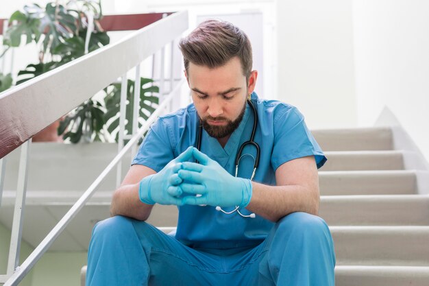 Close-up male nurse taking a break at work