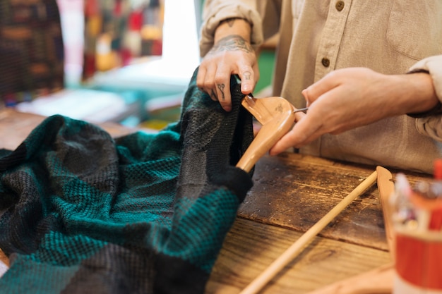 Free photo close-up of a male owner arranging clothes on hanger