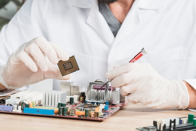 Close-up of a male technician holding computer chip