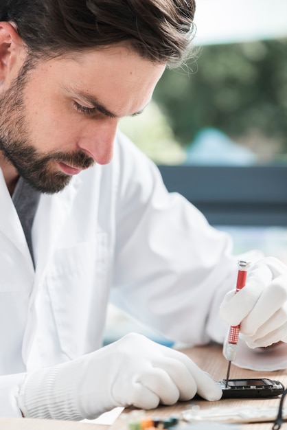 Close-up of a male technician repairing cellphone