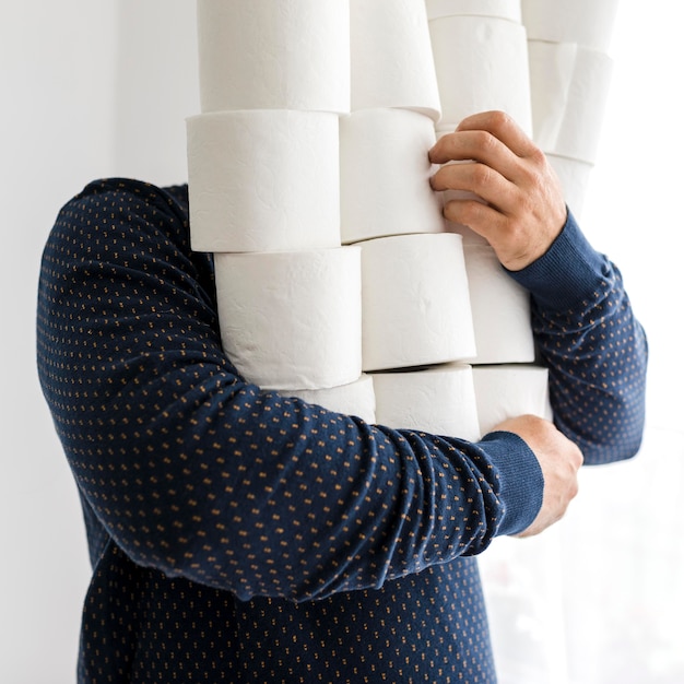 Close-up male with stack of toilet paper