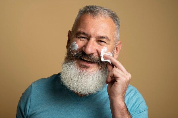 Close up man applying face cream