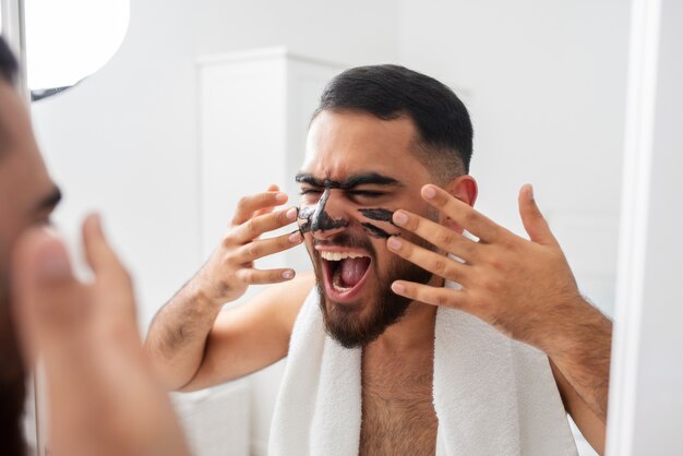 Close up man applying face mask