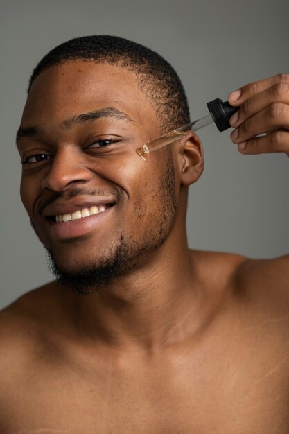 Close up man applying serum