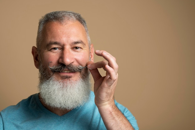 Close up man arranging moustache