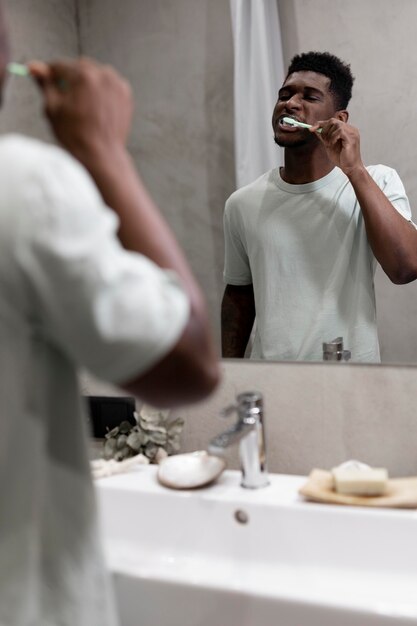 Close up man brushing teeth