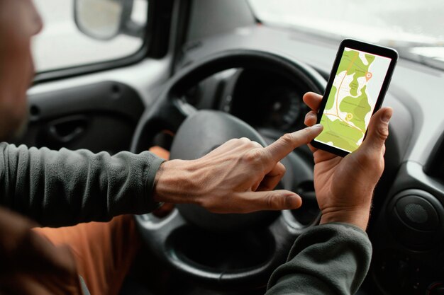 Close up man in the car with map on mobile