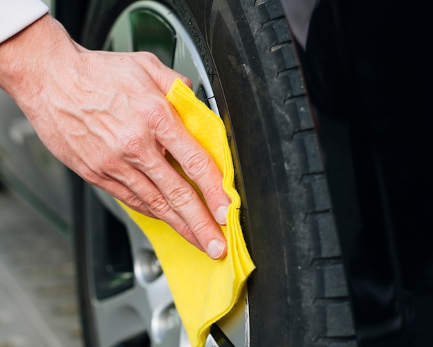 Close up of man cleaning car rims