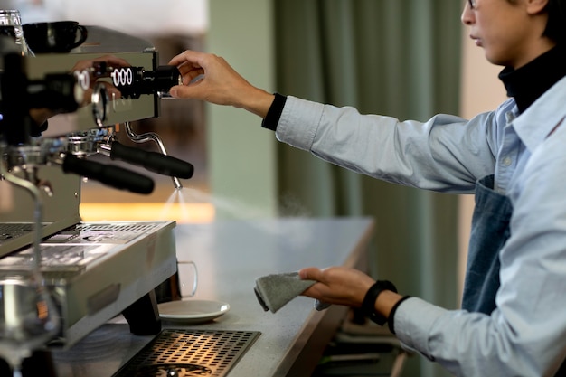 Close up man cleaning coffee machine