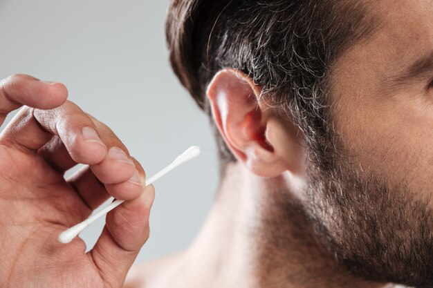 Close up of man cleaning his ears