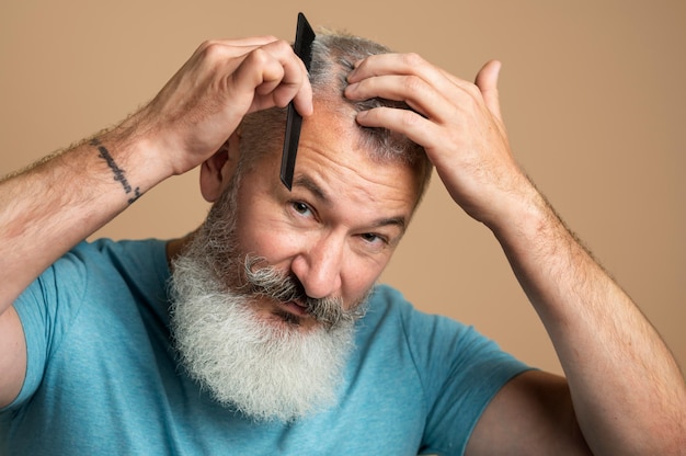 Close up man combing hair