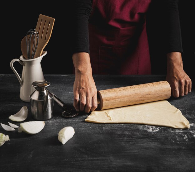 Close-up man cooking pizza