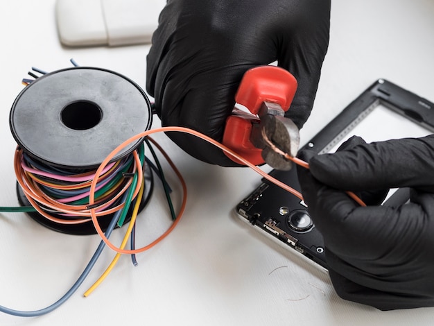 Close-up of man cutting wires