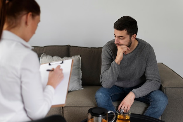 Close up man discussing with therapist