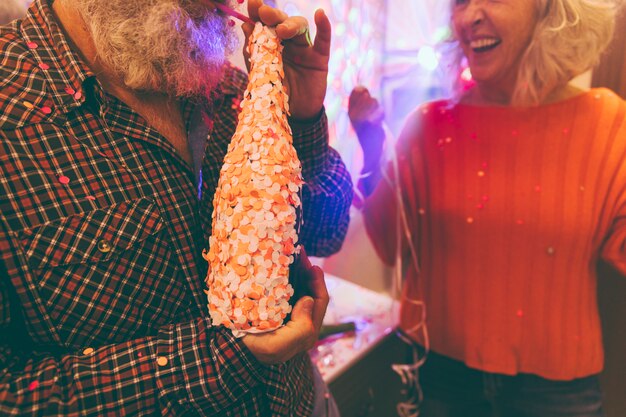 Close-up of a man drinking alcohol with straw on birthday party