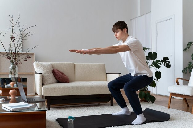 Close up on man exercising after online instructor