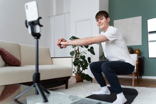 Close up on man exercising after online instructor