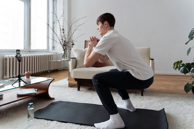 Close up on man exercising after online instructor