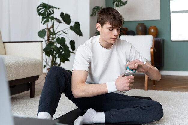 Close up on man exercising after online instructor