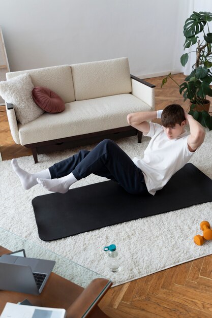 Close up on man exercising after online instructor