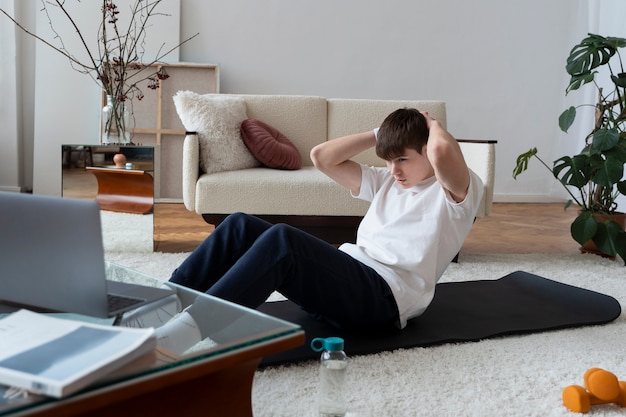 Close up on man exercising after online instructor