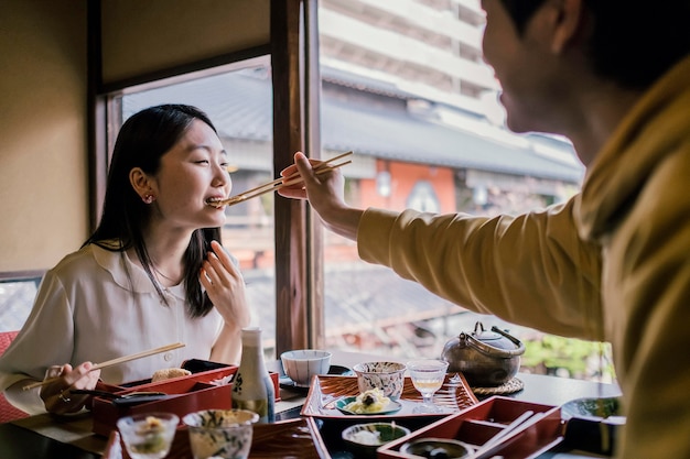 Close up man feeding woman