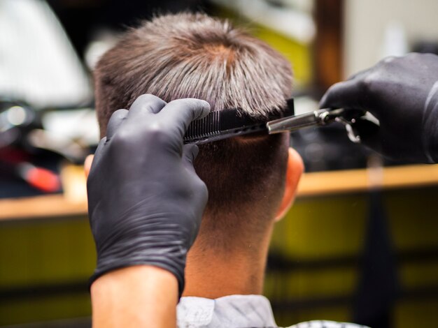 Close-up of man getting a haircut from behind