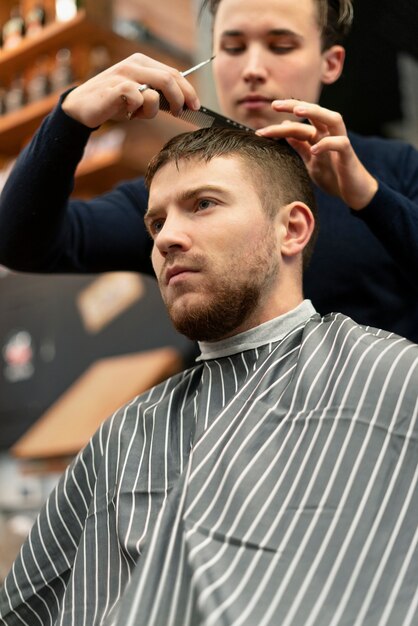 Close up man getting haircut at hairdresser shop