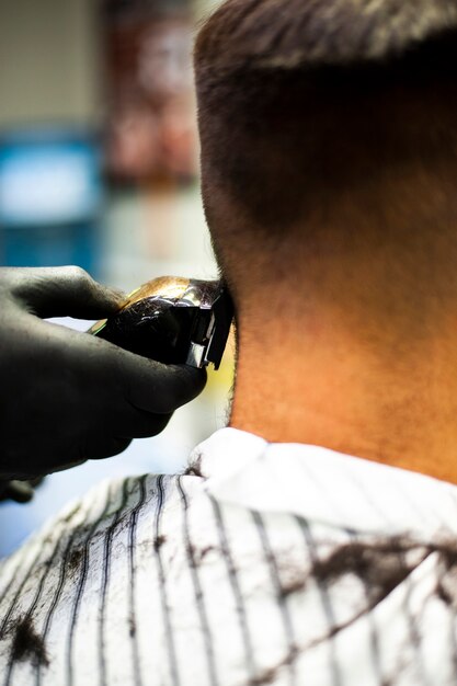 Close-up of man getting a haircut with trimmer