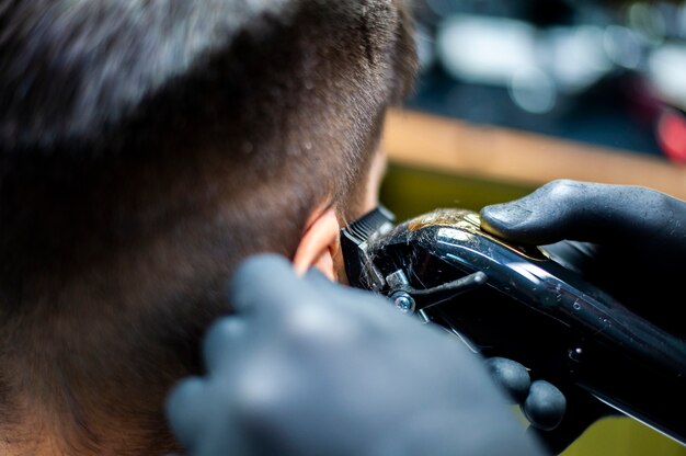 Close-up of man getting his hair cut