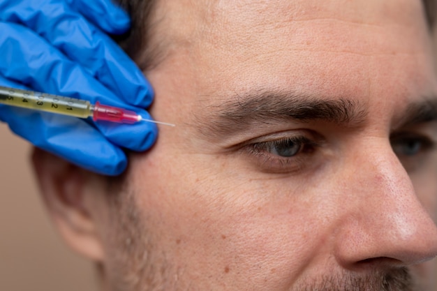 Free photo close up man getting prp injection