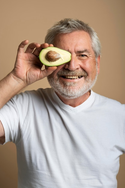 Close up man holding avocado