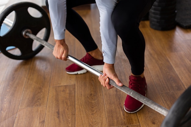 Close-up of man holding barbell