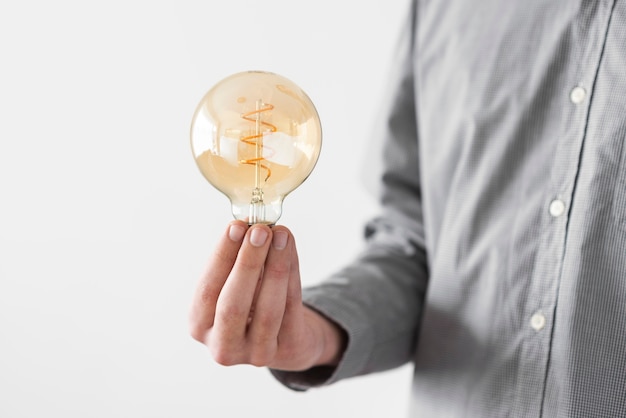 Close up man holding bulb