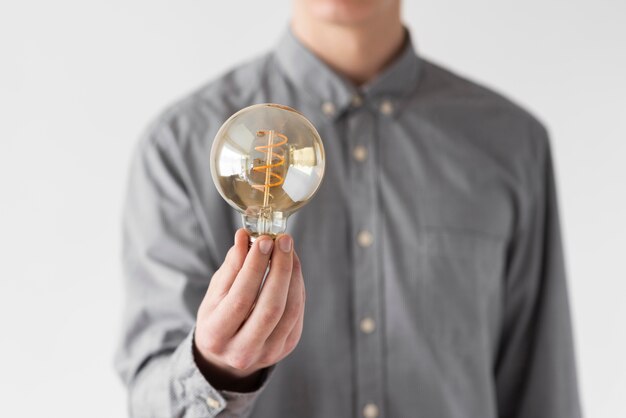 Close up man holding bulb