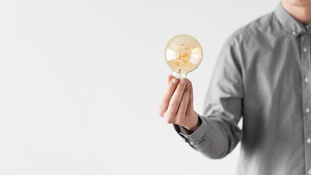 Close up man holding bulb