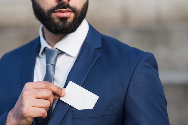 Close-up man holding business card