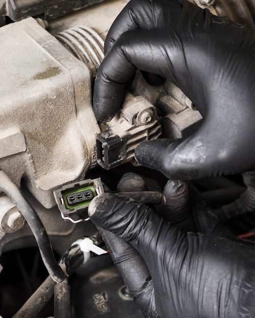 Close-up of man holding connector