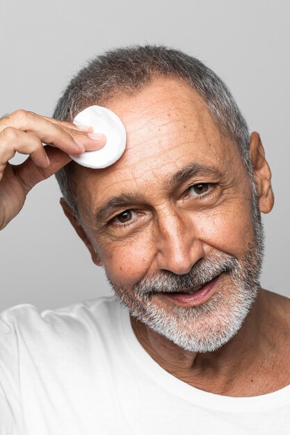 Close-up man holding cotton pad