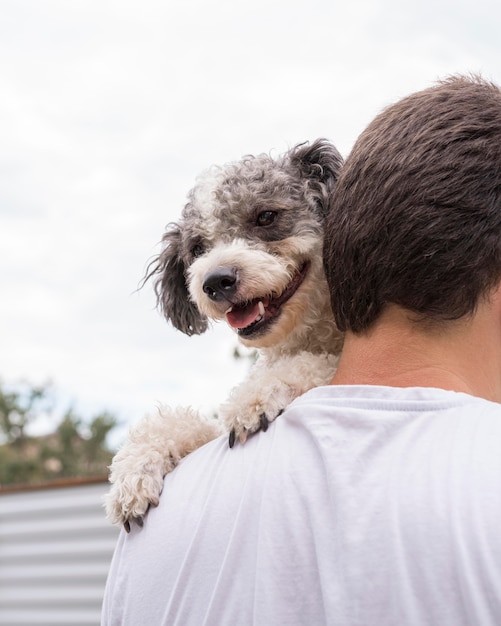 Free photo close-up man holding cute dog