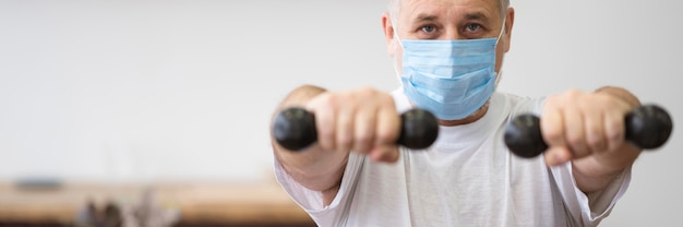 Close-up man holding dumbbells