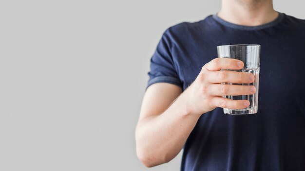 Close-up man holding glass