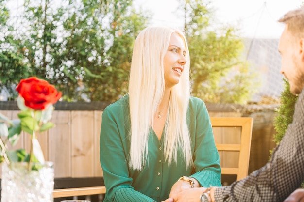 Close-up of man holding his girlfriend's hand looking away